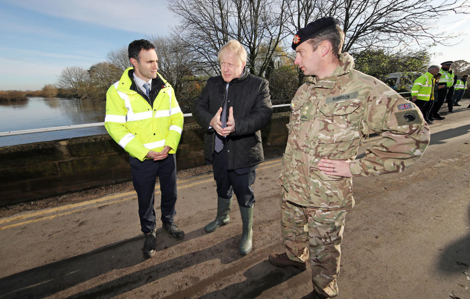 RETRANSMISSION, adding name of Environment Agency official. Prime Minister Boris Johnson walks with Lt Col Tom Robinson from the Light Dragoons and Oliver Harmar, Yorkshire Area Director of the Environment Agency, during a visit to Stainforth, Doncaster, to see the recent flooding.