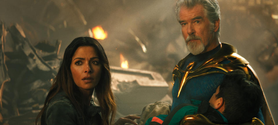 This image released by Warner Bros. Pictures shows Sarah Shahi, left, and Pierce Brosnan in a scene from "Black Adam." (Warner Bros. Pictures via AP)