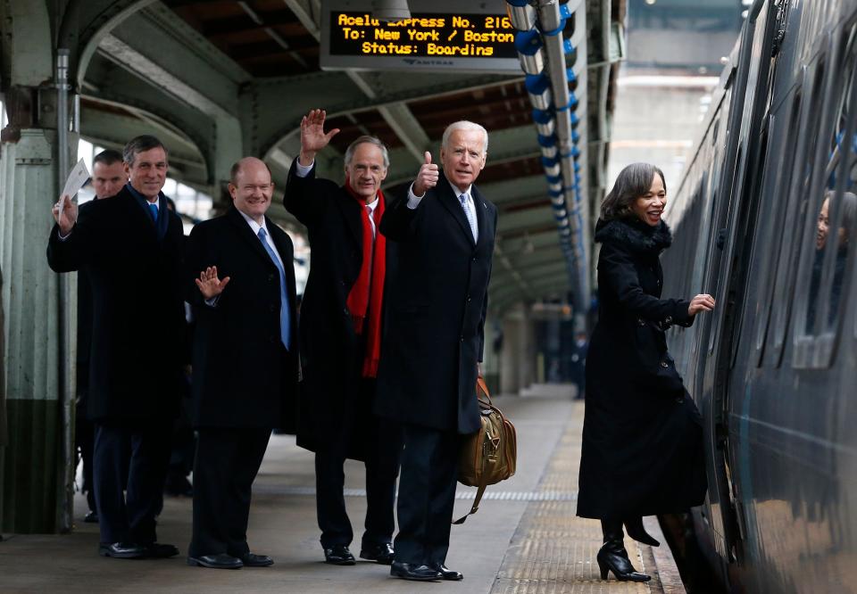 Delaware Gov. John Carney, left, Sens. Chris Coons and Tom Carper, now-President Joe Biden and Rep. Lisa Blunt Rochester board an Amtrak Acela train at Union Station bound for Wilmington, Del., after attending inauguration events on Jan. 20, 2017.