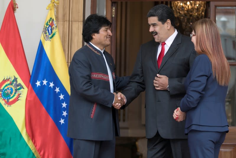 FILE PHOTO: Venezuela's President Nicolas Maduro shakes wands with Bolivia's President Evo Morales during the welcoming ceremony of an ALBA alliance summit in Caracas