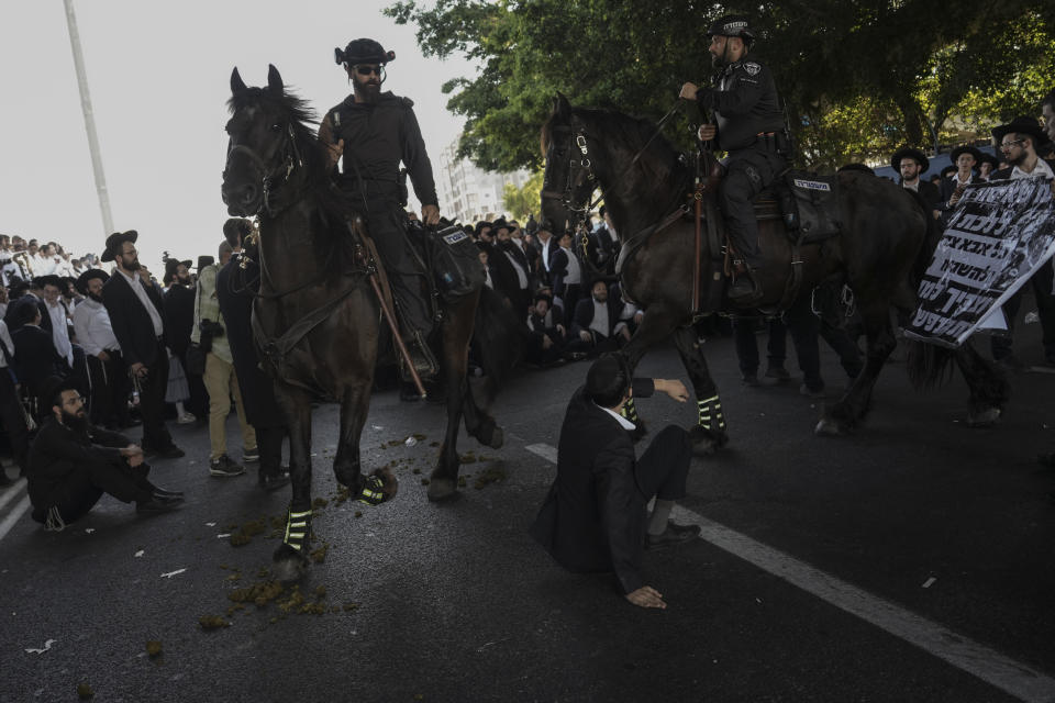 Israeli mounted police officers disperse Ultra-Orthodox Jews blocking a highway during a protest against army recruitment in Bnei Brak, Israel, Thursday, June 27, 2024. Israel's Supreme Court unanimously ordered the government to begin drafting ultra-Orthodox Jewish men into the army — a landmark ruling seeking to end a system that has allowed them to avoid enlistment into compulsory military service. (AP Photo/Oded Balilty)