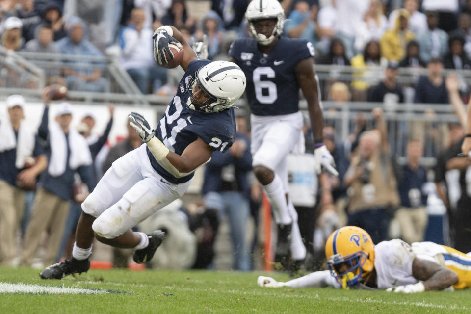 Penn State running back Noah Cain (21) eludes Pittsburgh defensive back Damar Hamlin (3) on his way to score on a 13-yard touchdown run in the third quarter of an NCAA college football game in State College, Pa., on Saturday, Sept. 14, 2019. Penn State defeated Pittsburgh 17-10. (AP Photo/Barry Reeger)