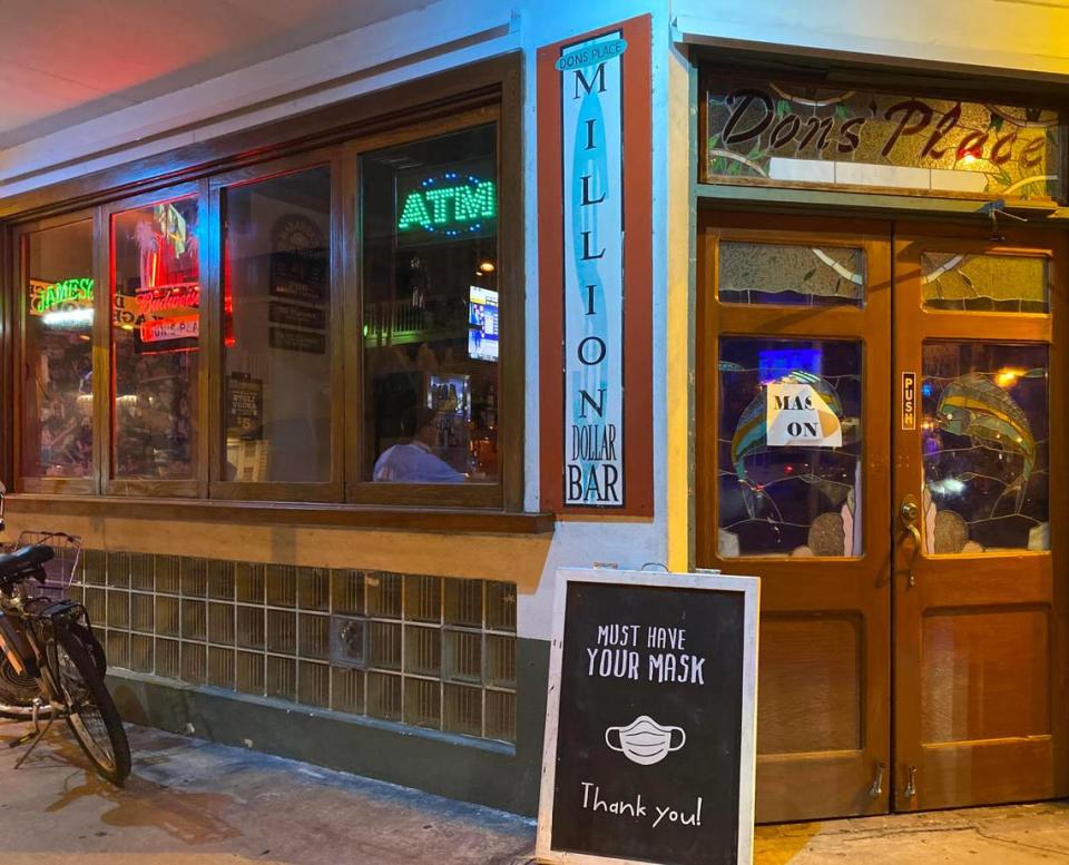 Dons’ Place in Key West reminds customers to wear their masks when entering the bar.