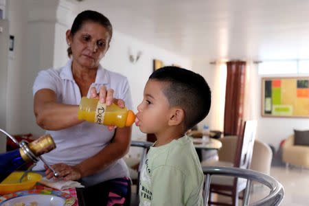 Ines Guerrero feeds her grandson Derek Ruiz in Guatire, Venezuela November 14, 2018. Picture taken November 14, 2018. REUTERS/Marco Bello