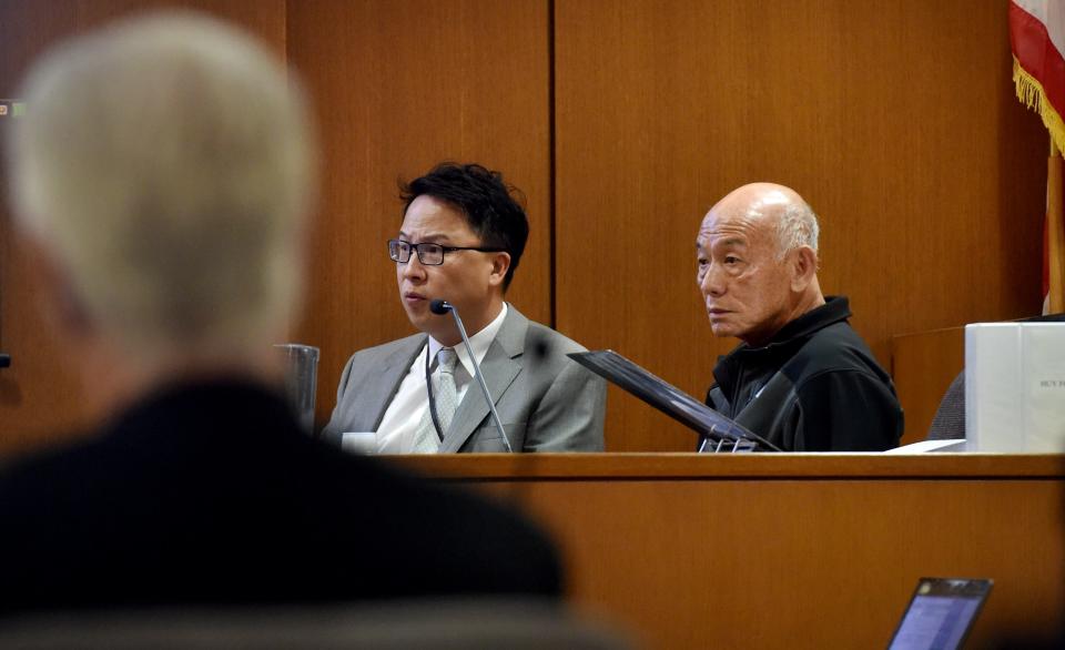 In this 2019 photo, Huy Fong Foods founder David Tran, right, takes the witness stand along with interpreter Michael Hong in a civil trial between the Sriracha maker and Ventura County grower Underwood Ranches.