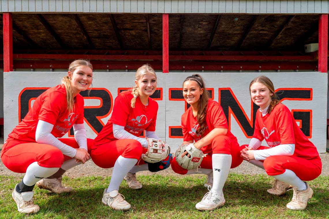 Orting High School softball players (from left) senior pitcher Kaylee Gresko, junior catcher Miken Jacobsen, senior shortstop Abbi Almont, and sophomore third baseman Madalynn Halte, pose for a portrait in Orting, Wash., on Monday, April 24, 2023.