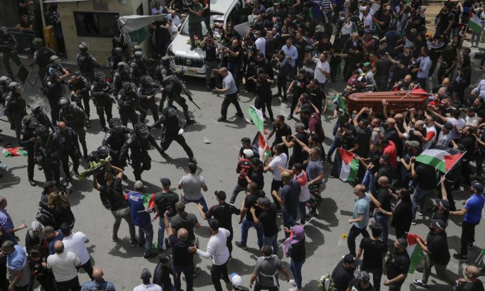 Israeli police confront mourners as they carry the casket of Shireen Abu Aqleh on Friday.