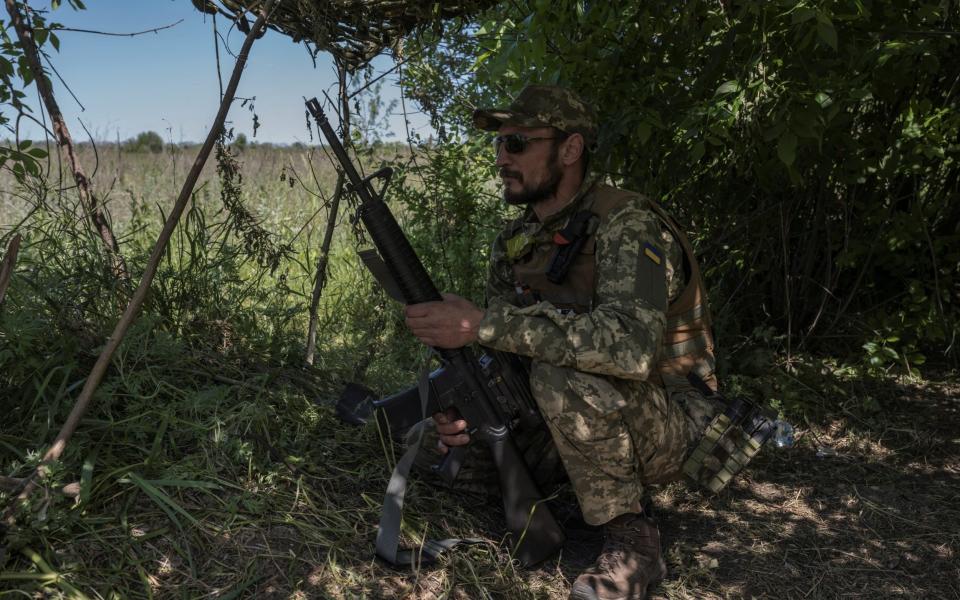 A Ukrainian serviceman looks on near the Ukraine-Russia border - VIACHESLAV RATYNSKYI/REUTERS
