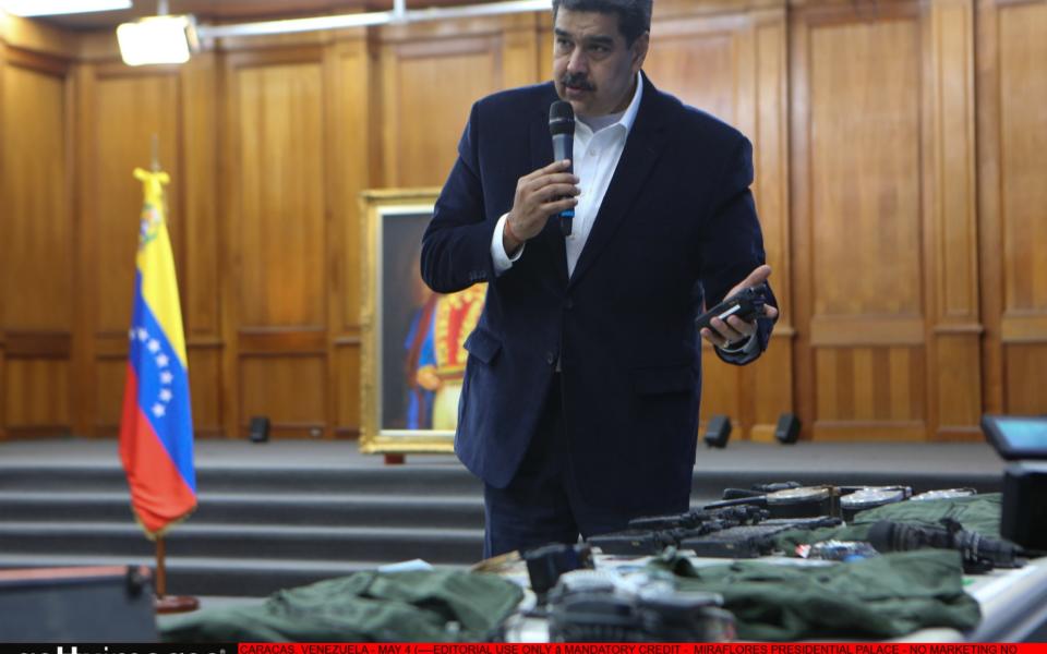 Nicolas Maduro, seen here parading guns and passports seized during the coup, is likely to demand concessions in return for the soldiers' release - Anadolu Agency