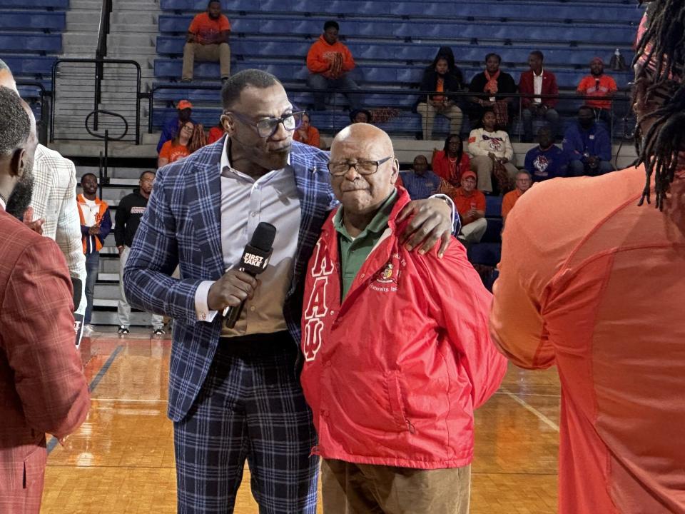 Shannon Sharpe with his Glennville High School football coach William Hall Monday at Savannah State.