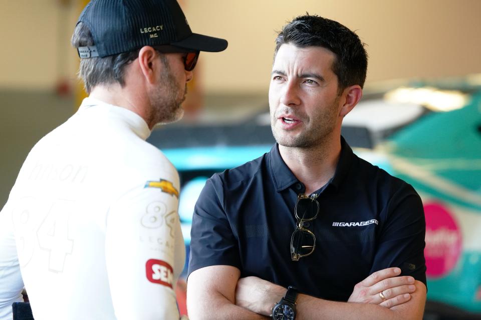 Feb 17, 2023; Daytona Beach, Florida, USA; German race car driver Mike Rockenfeller talks with NASCAR Cup Series driver Jimmie Johnson (84) in his garage stall before practice for the Daytona 500 at Daytona International Speedway.