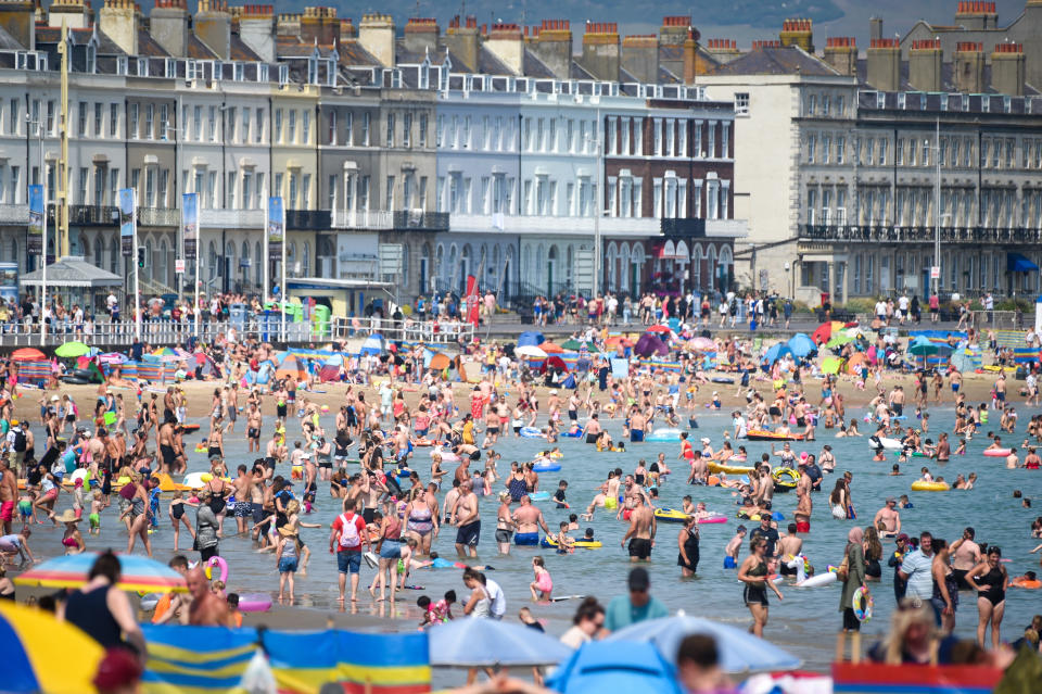 Visitors to the beach in Weymouth on 9 August.