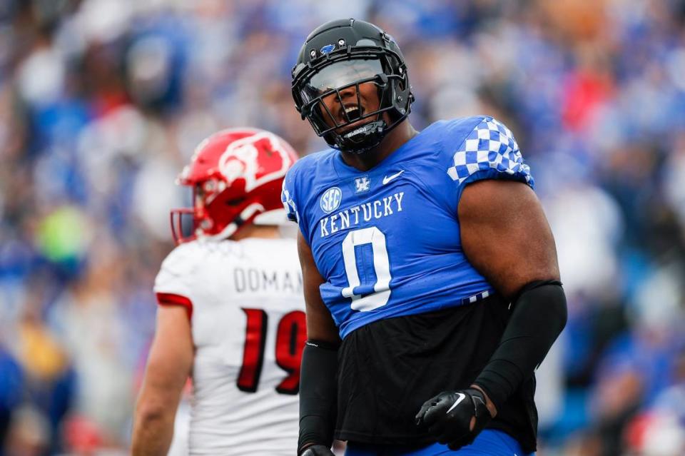 Kentucky defensive tackle Deone Walker (0) celebrates after one of his six tackles in UK’s 26-13 victory over archrival Louisville on Saturday.