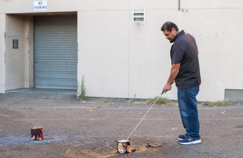 Rafael Cortez with TNT Fireworks extinguishes lingering flames from the Phantom Fireworks’ Radioactive Spark fountain on Monday. Cortez assisted the Sacramento Bee’s interns in their process of reviewing 26 different fireworks.