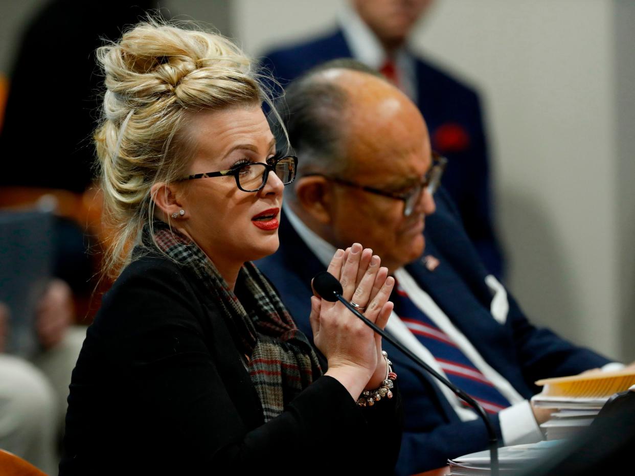 <p>Melissa Carone, who was working for Dominion Voting Services, speaks in front of the Michigan House Oversight Committee in Lansing, Michigan on 2 December 2020</p> ((AFP via Getty Images))