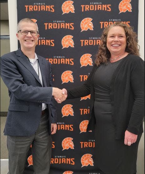 Sturgis Public Schools Superintendent Art Ebert welcomes Britt Gross to the position of assistant superintendent following a board of education meeting Monday.