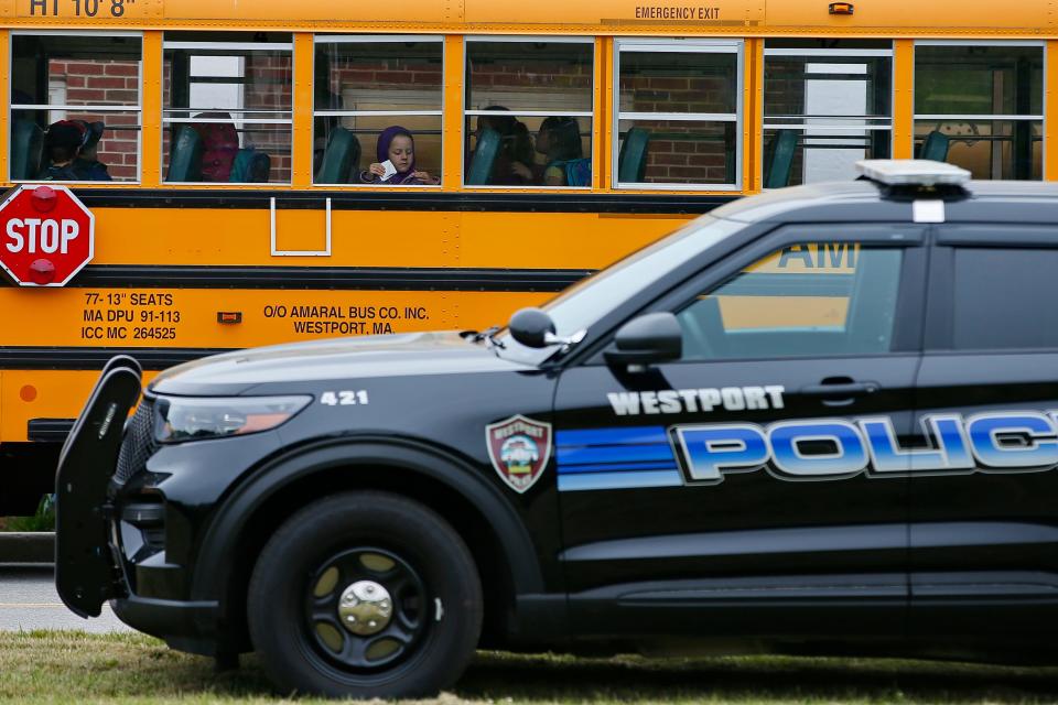 A Westport police cruiser is seen parked out front as students arrive at the Alice Macomber school on Gifford Road in Westport.