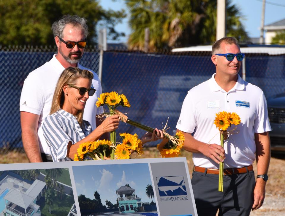 Swim Melbourne Foundation officials distributed flowers during Thursday's Palm Shores Aquatic Facility groundbreaking ceremony.