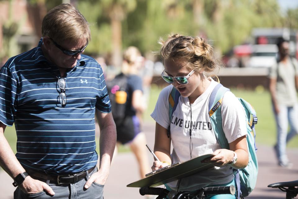 Chris Wayne helps Katherine Graves sign up to be interviewed.