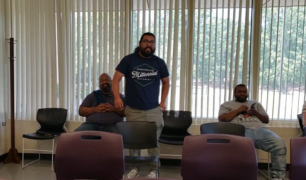 Mario Benavente, standing, reacts after hearing he has maintained a six-vote lead for the District 3 seat for Fayetteville City Council, in a meeting of the Cumberland County Board of Elections on Friday, Aug. 5, 2022. The board conducted the official canvass of the election, which was held on July 26, 2022. Antonio Jones, the incumbent councilman in Dist. 3, can request a recount under state law.