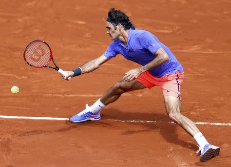 Roger Federer of Switzerland plays a shot to Marcel Granollers of Spain during their men's singles match at the French Open tennis tournament at the Roland Garros stadium in Paris, France, May 27, 2015. REUTERS/Vincent Kessler