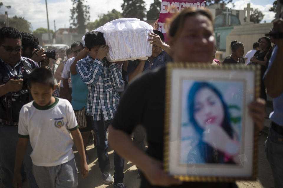 Relatives carry the coffin containing the remains of 17-year-old Siona Hernandez Garcia, a girl who died in a fire at the Virgin of the Assumption Safe Home, at the Guatemala City's cemetery, Friday, March 10, 2017. Families began burying some of the 36 girls killed in a fire at an overcrowded government-run youth shelter in Guatemala as authorities worked to determine exactly what happened. (AP Photo/Luis Soto)