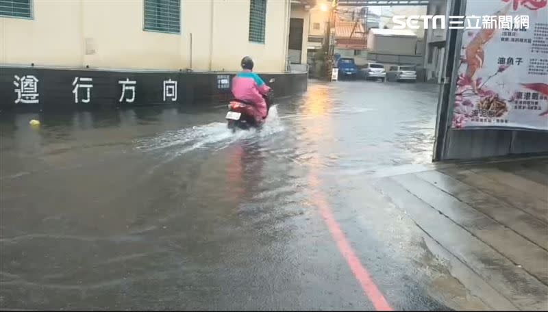 東港地勢低窪處出現淹水情形，用路人涉水而過。（圖／翻攝畫面）