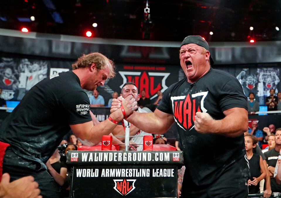 Jerry Cadorette, of Rehoboth, Mass., right, celebrates his win over Matt Mask, of Red Deer, Alberta, Canada, in the World Armwrestling League Championships in Atlanta on Sept. 5, 2018. 