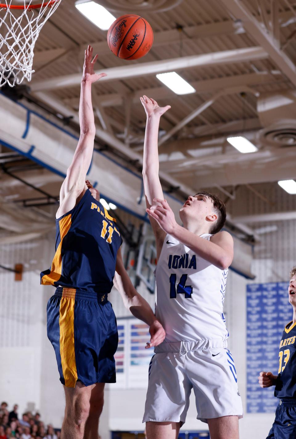 Ionia's Lance Atkinson, right, puts up a shot against Pewamo-Westphalia's Jamison Eklund, Tuesday, Dec. 21, 2021, in Ionia. P-W won 43-38.