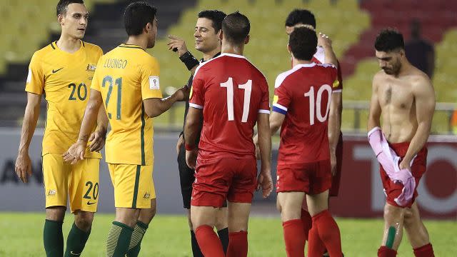 Players protest with the referee. Image: Getty