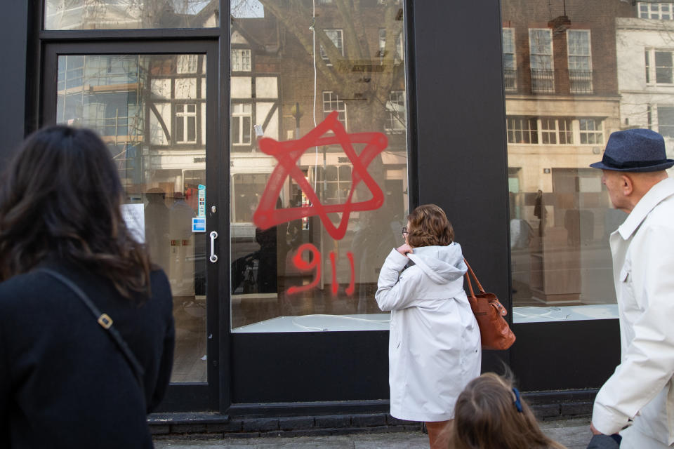 Anti-semitic graffiti in the form of numbers, 9 11, and a Star of David, on a shop window in Belsize Park, North London.