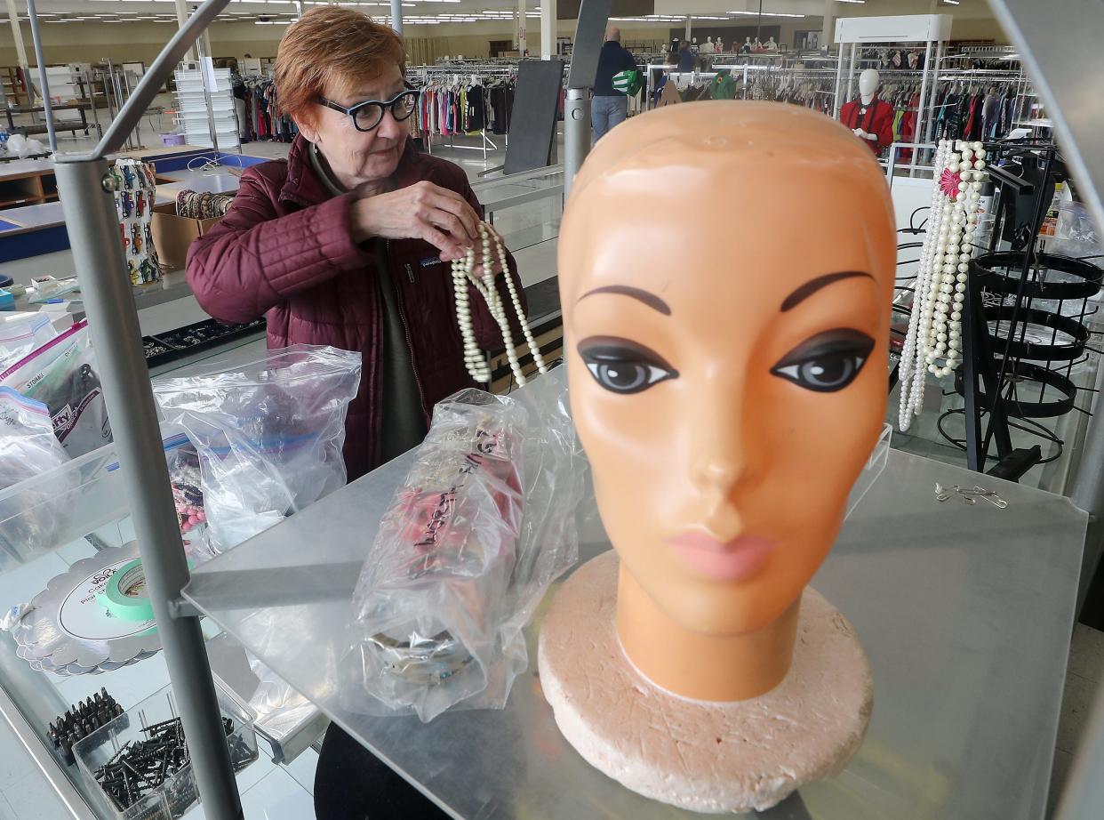 St Vincent de Paul director of giving Katie Silva unpacks bags of jewelry as she helps get the jewelry section ready for business at the new St. Vincent de Paul Super Store ready on Wednesday, Mar. 1, 2023.