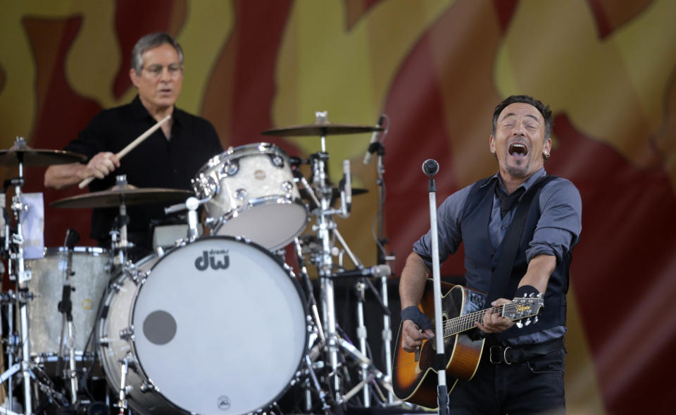 Bruce Springsteen performs with drummer Max Weinstein at the New Orleans Jazz and Heritage Festival in New Orleans, Saturday, May 3, 2014. (AP Photo/Gerald Herbert)