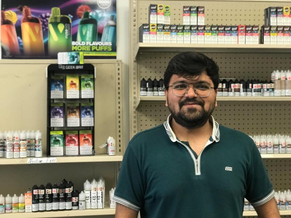 Sahil Marsoniya works at Ottawa Vape on June 30, 2024. He said he has seen customers buy five or six vapes in one transaction to prepare for an expected price hike.