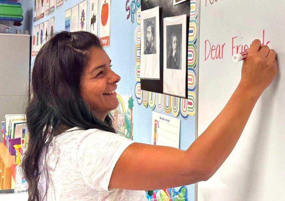 Priscilla Escobedo, pre-kindergarten and kindergarten teacher, writes on a board in class at Holy Family Classical Academy Oct. 23, 2023.
