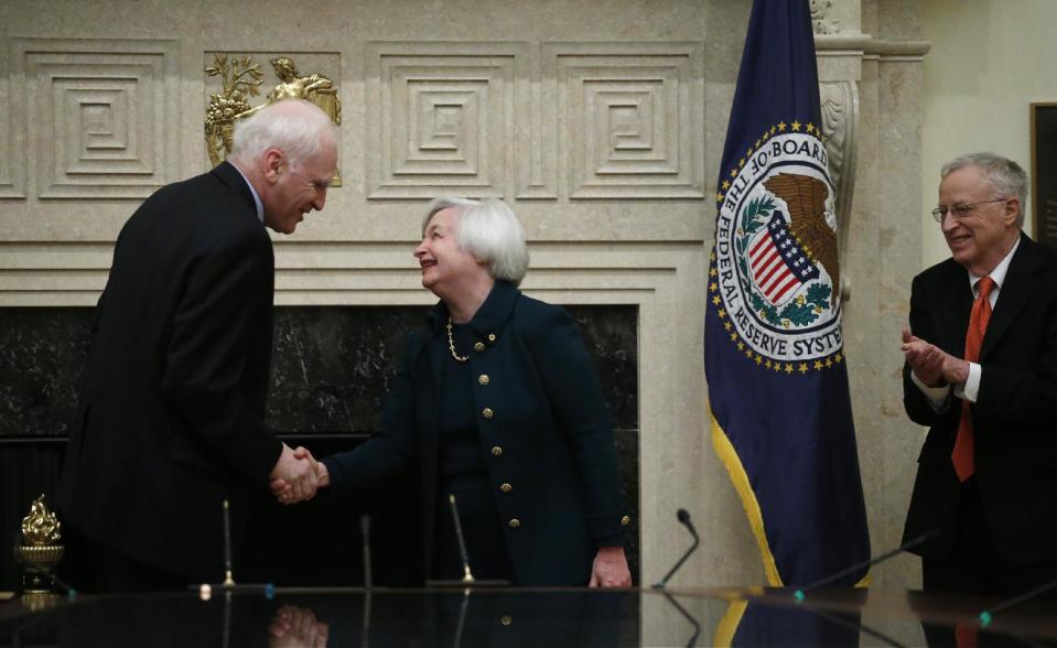 Janet Yellen shakes hands with Fed Board Gov. Daniel K. Tarullo, left, after she was administered the oath of office as Federal Reserve Board chair, Monday, Feb. 3, 2014, at the Federal Reserve in Washington. Yellen's husband, Nobel Prize winning economist George Akerlof applauds at right. Yellen, is the first woman to lead the Federal Reserve. (AP Photo/Charles Dharapak)