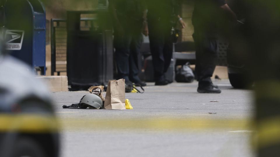 Police investigate after a shooting at a supermarket, Saturday, May 14, 2022, in Buffalo, N.Y.