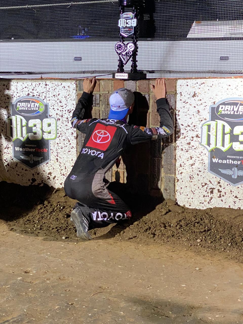 Buddy Kofoid "kisses the bricks" following his BC39 feature victory at the Indianapolis Motor Speedway Dirt Track