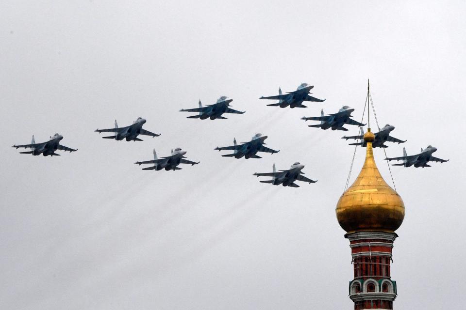 Russian Sukhoi Su-35S fighter aircraft, Su-34 military fighter aircraft and Su-30SM jet fighters fly in formation over central Moscow during the Victory Day military parade on May 9, 2021