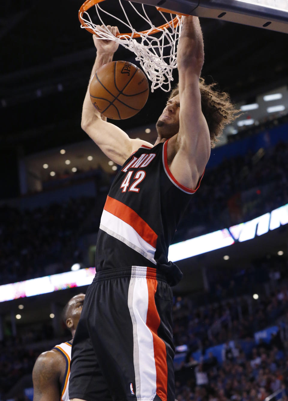 Portland Trail Blazers center Robin Lopez (42) dunks in front of Oklahoma City Thunder center Kendrick Perkins (5) in the first quarter of an NBA basketball game in Oklahoma City, Tuesday, Jan. 21, 2014. (AP Photo/Sue Ogrocki)