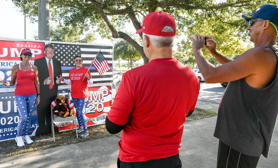 Dana Blickley and Joyce Loyd have their pictures taken with a cutout of Donald Trump by Brian Blickley and Greg Loyd in Viera Regional Park Tuesday, Nov. 3, 2020. Mandatory Credit: Craig Bailey/FLORIDA TODAY via USA TODAY NETWORK