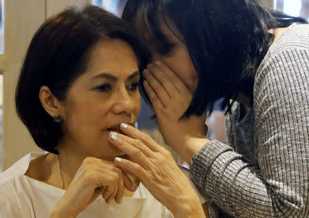 Philippine Environment secretary Regina Lopez listens to her aide during a meeting in Manila, Philippines February 9, 2017. REUTERS/Erik De Castro