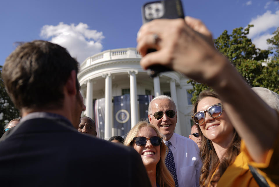 FILE - President Joe Biden poses for photos after speaking about the Inflation Reduction Act of 2022 during a ceremony on the South Lawn of the White House in Washington, Sept. 13, 2022. (AP Photo/Andrew Harnik, File)