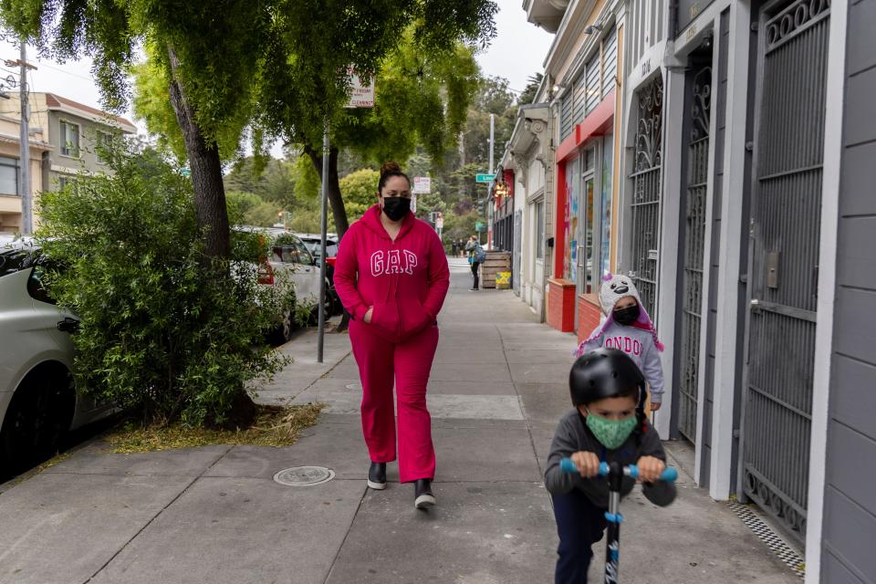 Lily Marquez, a married mother of two, on a walk with her family in San Francisco, Calif. on June 25, 2021. Marquez said she planned to use money from child tax credit on dental work for her daughter,  extra lessons for her son and repairs for the family car.
