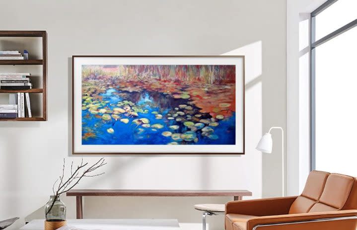 SAMSUNG QLED 4K LS03B Series The Frame Smart TV on living room wall showing a nature scene.