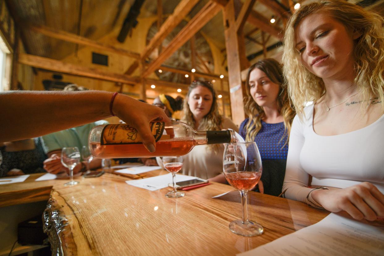 Customers enjoy the wine and the atmosphere of Bishop Estate Vineyard and Winery's historical barn & our "coop" area, which is one of many tasting areas on the Perkasie farm.