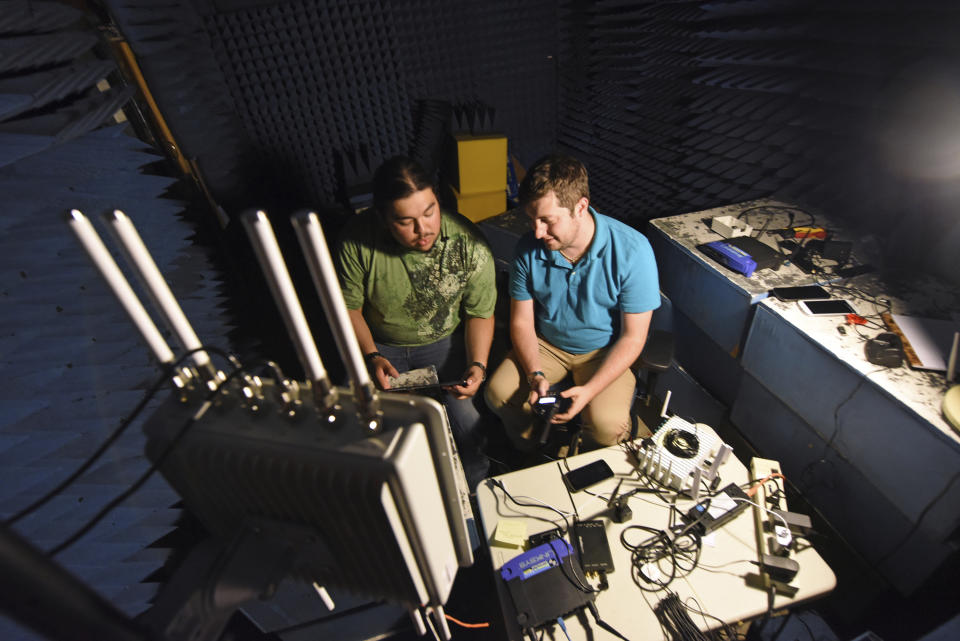 In this September 2018 photo provided by the Idaho National Laboratory, INL interns Armando Juarez Jr., left, and Jordan Mussman work in the Faraday room in a cybersecurity electronics lab in Idaho Falls, Idaho. The Idaho National Laboratory next year will move into a massive cybersecurity building and another that will house one of the nation’s most powerful supercomputers. (Chris Morgan/Idaho National Laboratory via AP)