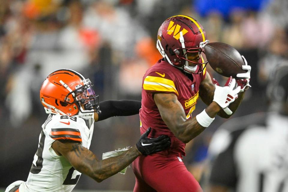 Washington Commanders wide receiver Dyami Brown catches a pass over Cleveland Browns cornerback Cameron Mitchell on Aug. 11 in Cleveland.