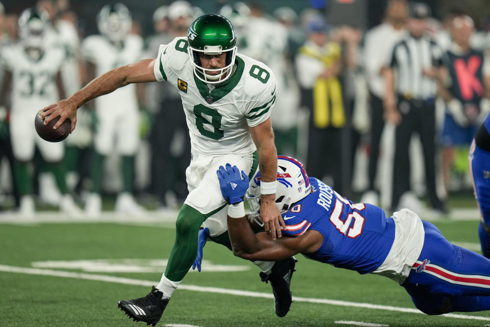 New York Jets quarterback Aaron Rodgers (8) avoids a sack from Buffalo Bills defensive end Greg Rousseau (50) during the first quarter of an NFL football game, Monday, Sept. 11, 2023, in East Rutherford, N.J. (AP Photo/Seth Wenig)