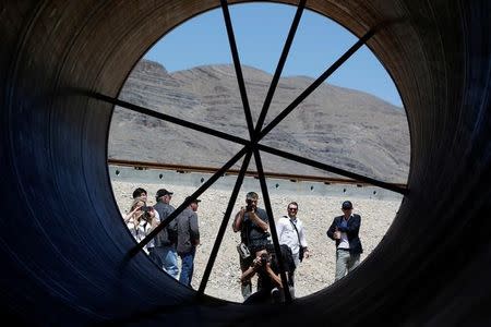 Journalists take photos of a tube following a propulsion open-air test at Hyperloop One in North Las Vegas, Nevada, U.S. May 11, 2016. REUTERS/Steve Marcus